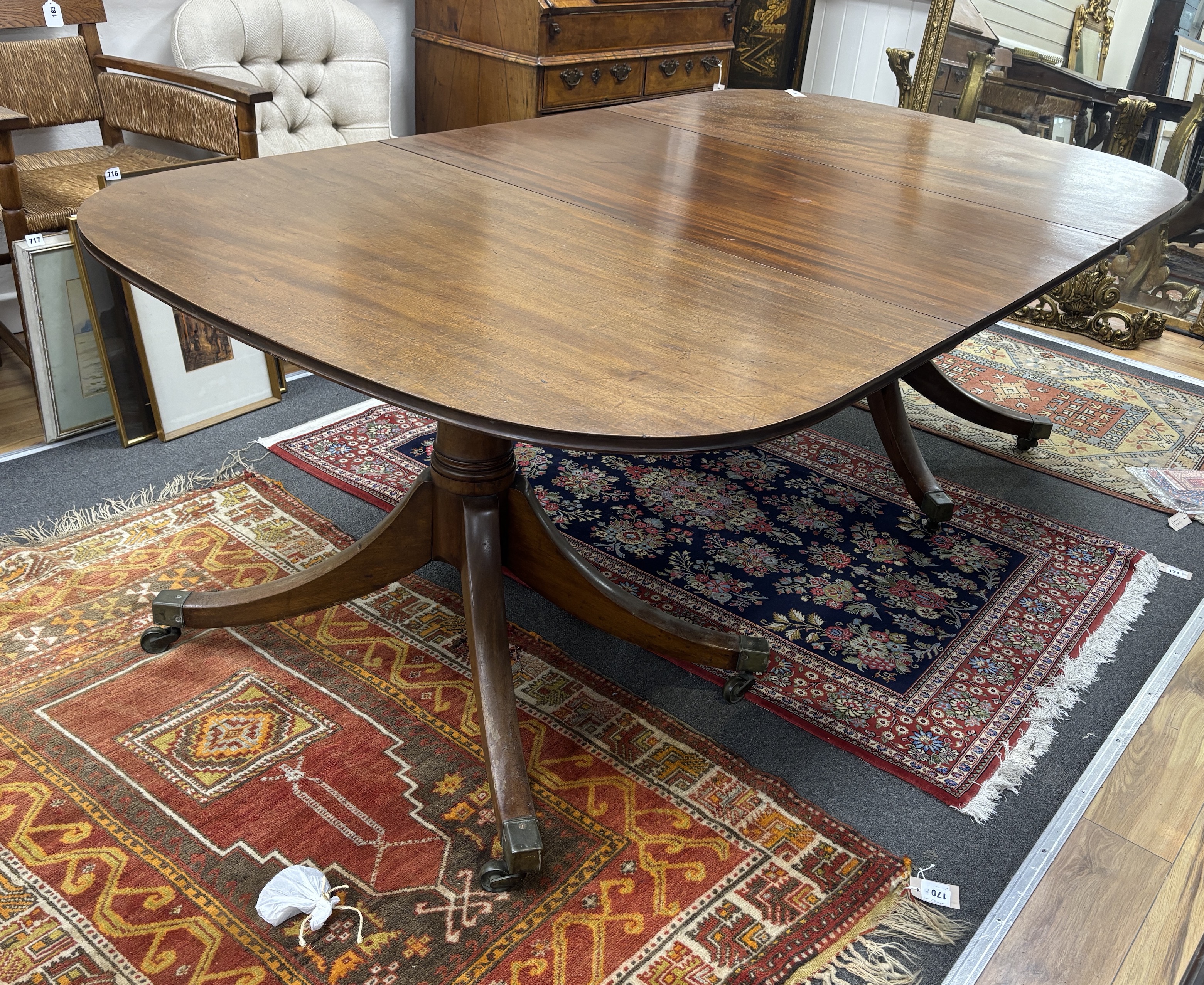 A Regency mahogany twin pillar extending dining table, 208cm extended, one spare leaf (with one other leaf but lacks extension bars, depth 116cm, height 71cm